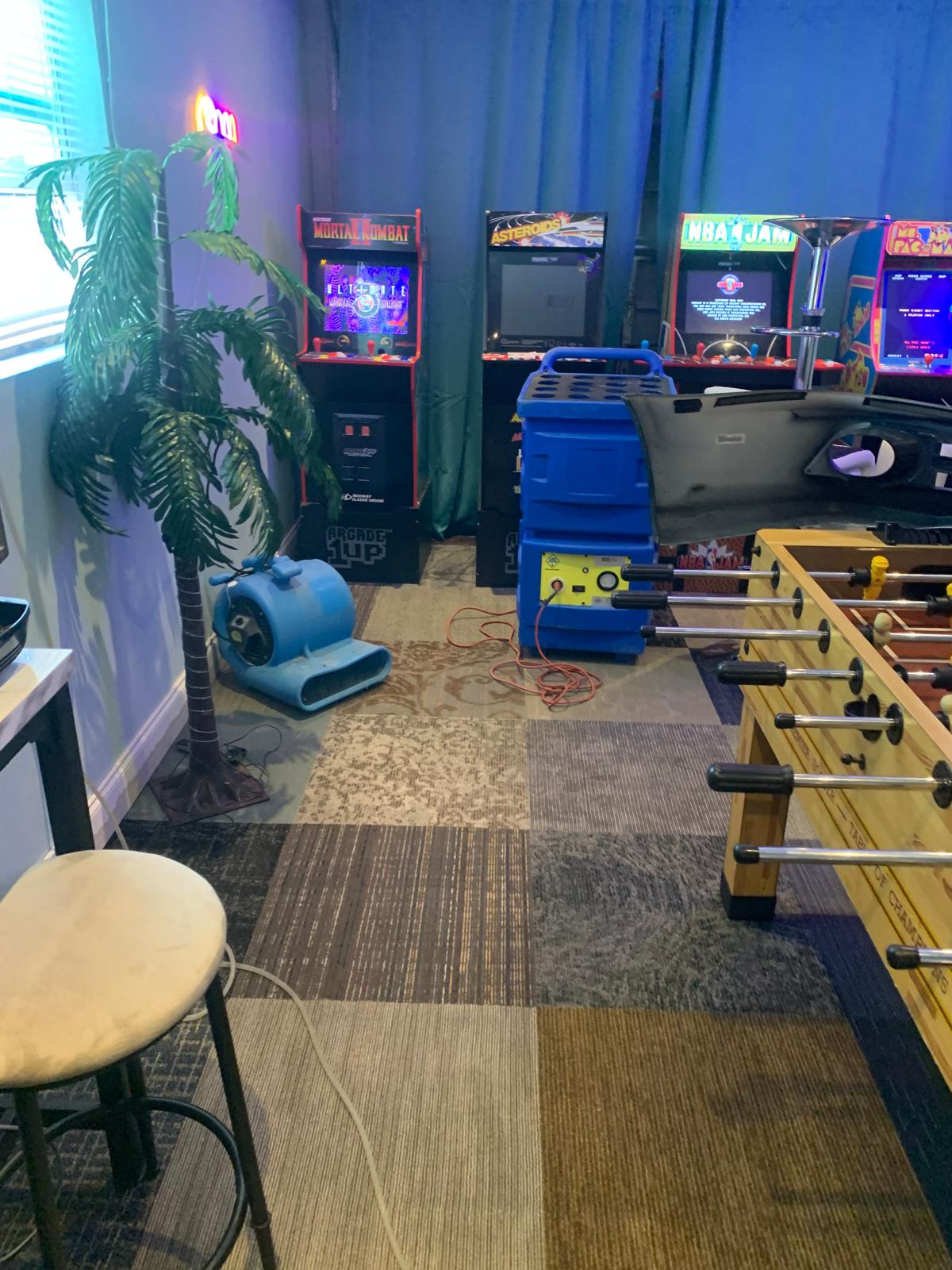 Commercial drying equipment positioned inside a carpeted recreation space