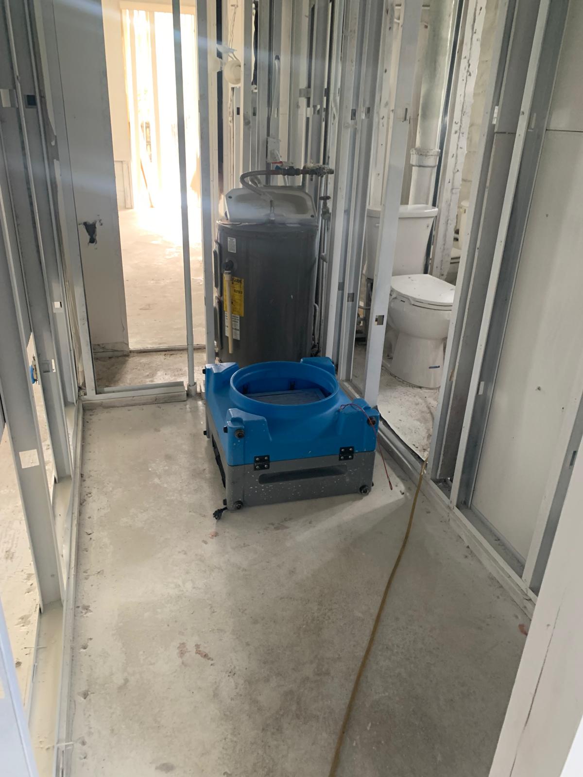 Professional drying equipment operating during an interior water-damage restoration project